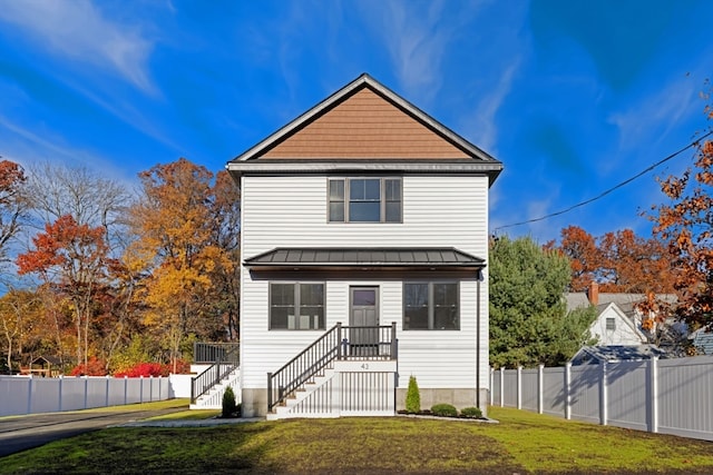 view of property featuring a front lawn