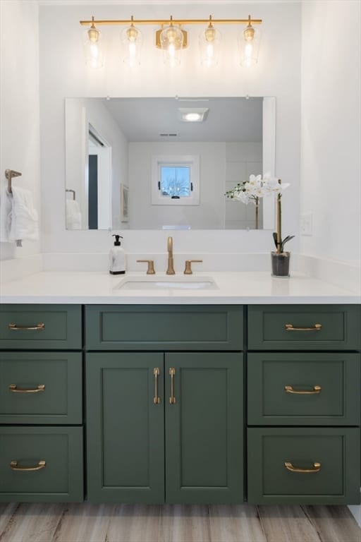 bathroom with vanity and hardwood / wood-style floors