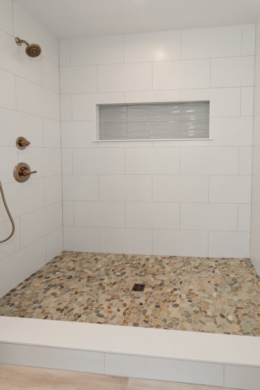 bathroom with a tile shower