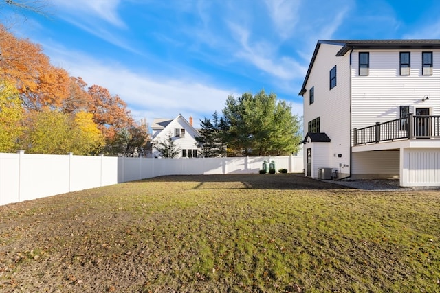 view of yard with central AC and a deck