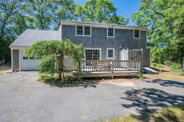 view of front of property with a garage and a wooden deck