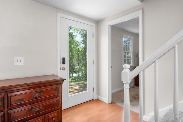 doorway to outside with light wood-type flooring