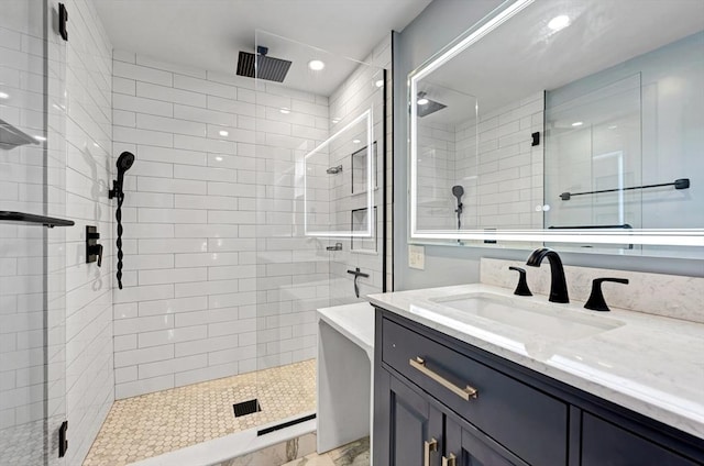 bathroom featuring a stall shower, vanity, and recessed lighting