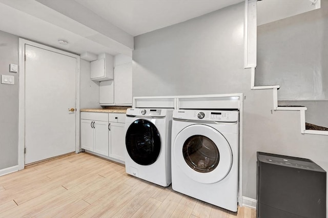 laundry room featuring separate washer and dryer, light wood-style floors, and baseboards