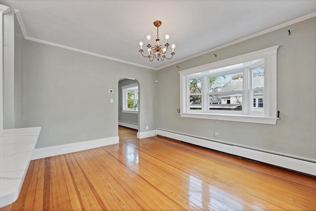 empty room with a baseboard radiator, arched walkways, hardwood / wood-style flooring, a chandelier, and ornamental molding