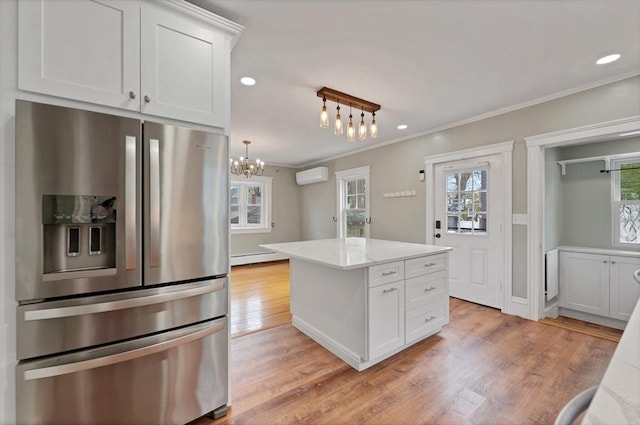 kitchen with stainless steel fridge with ice dispenser, crown molding, a wall mounted AC, a chandelier, and light wood-style floors