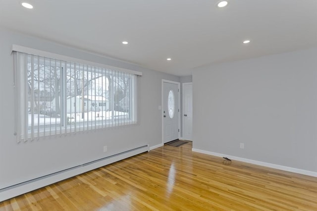 entryway with light wood-style floors, a baseboard radiator, baseboards, and recessed lighting