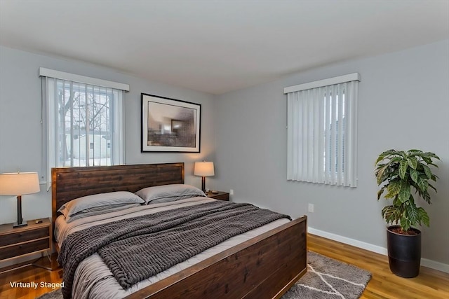 bedroom featuring wood finished floors and baseboards