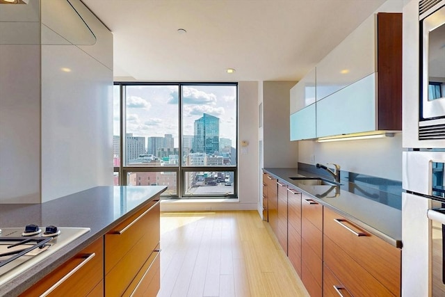 45 Province St Unit U1602, Boston, MA 02108 - kitchen featuring a sink, gas cooktop, modern cabinets, floor to ceiling windows, and wall oven