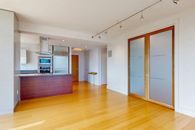 45 Province St Unit U1602, Boston, MA 02108 - unfurnished living room featuring light wood-style floors and rail lighting