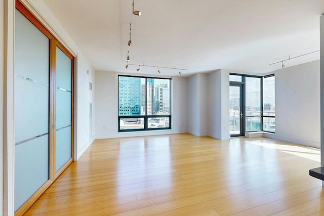 45 Province St Unit U1602, Boston, MA 02108 - empty room with rail lighting, light wood-type flooring, and baseboards