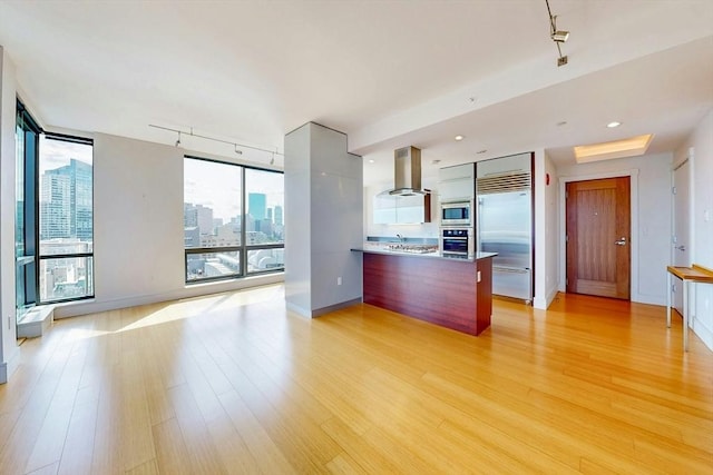 45 Province St Unit U1602, Boston, MA 02108 - kitchen with built in appliances, island exhaust hood, modern cabinets, light wood finished floors, and a wall of windows