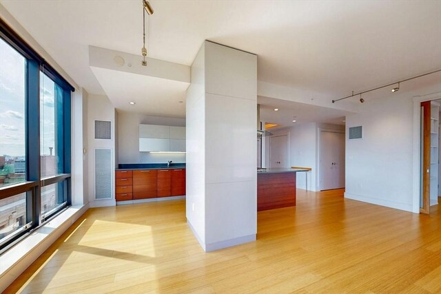 45 Province St Unit U1602, Boston, MA 02108 - kitchen with modern cabinets, rail lighting, light wood-style flooring, a sink, and open floor plan