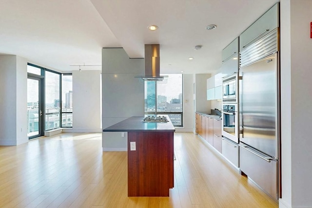 45 Province St Unit U1602, Boston, MA 02108 - kitchen with built in appliances, island range hood, light wood finished floors, modern cabinets, and floor to ceiling windows