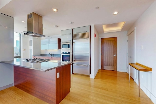 45 Province St Unit U1602, Boston, MA 02108 - kitchen featuring built in appliances, modern cabinets, island range hood, light wood-style flooring, and a peninsula