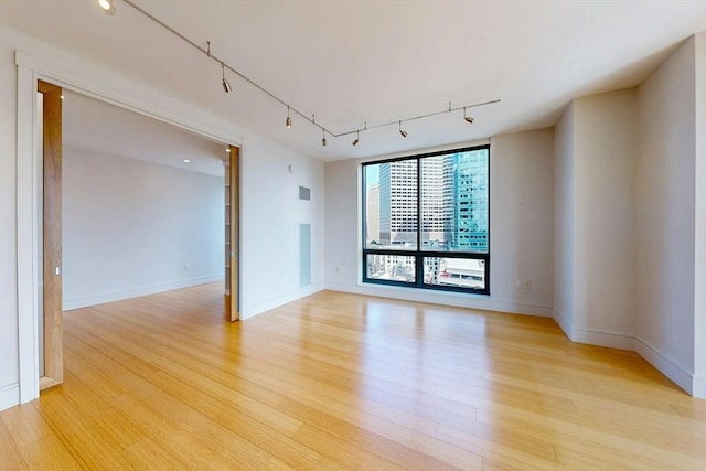 45 Province St Unit U1602, Boston, MA 02108 - empty room featuring rail lighting, light wood-type flooring, and baseboards