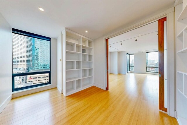 45 Province St Unit U1602, Boston, MA 02108 - spare room with wood finished floors, baseboards, rail lighting, and recessed lighting