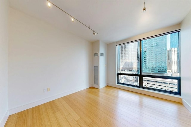 45 Province St Unit U1602, Boston, MA 02108 - empty room with wood finished floors, rail lighting, and baseboards