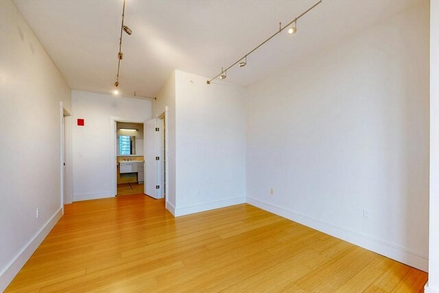 45 Province St Unit U1602, Boston, MA 02108 - empty room with light wood-style floors, rail lighting, and baseboards