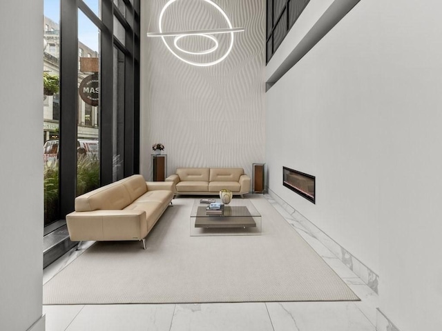 45 Province St Unit U1602, Boston, MA 02108 - living area with a towering ceiling, marble finish floors, and a glass covered fireplace
