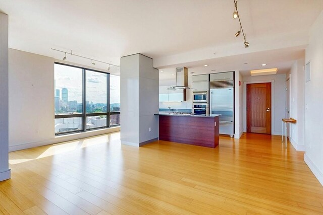 45 Province St Unit U1602, Boston, MA 02108 - kitchen with track lighting, built in appliances, modern cabinets, light wood finished floors, and baseboards