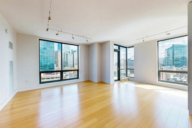 45 Province St Unit U1602, Boston, MA 02108 - spare room featuring rail lighting, plenty of natural light, light wood-style flooring, and baseboards