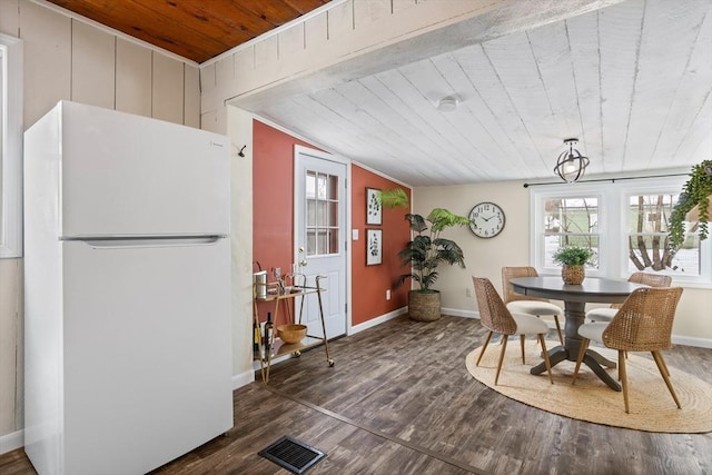 dining space with dark wood-style flooring, visible vents, wooden ceiling, and baseboards