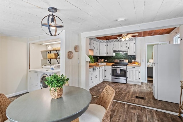 dining area featuring dark wood-style floors, washing machine and clothes dryer, visible vents, ceiling fan, and baseboards