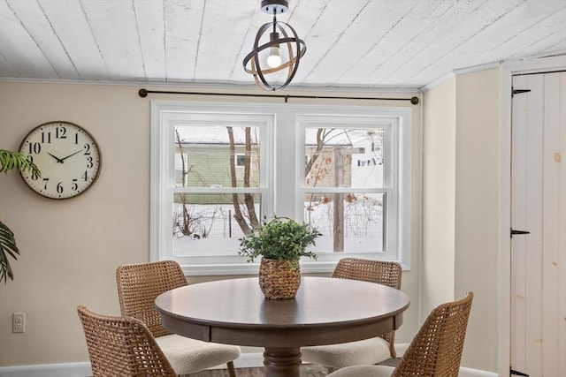 dining space featuring plenty of natural light, wooden ceiling, and crown molding