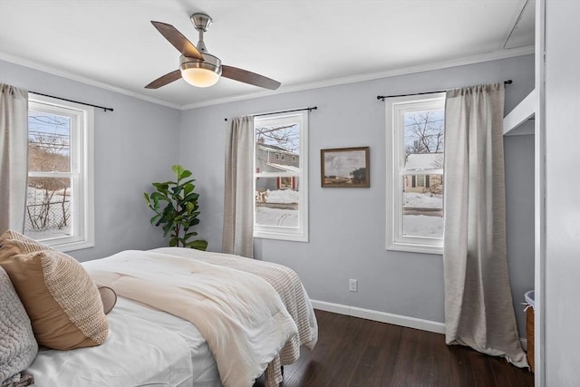 bedroom with a ceiling fan, crown molding, baseboards, and dark wood-type flooring