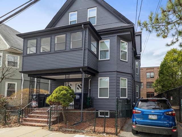 9-11 Edmunds St, Cambridge, MA 02140 - view of front of house with a porch and a fenced front yard
