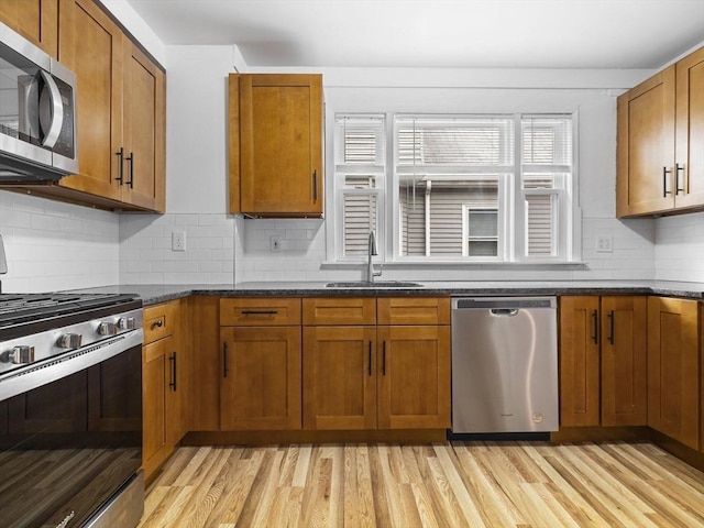 9-11 Edmunds St, Cambridge, MA 02140 - kitchen featuring stainless steel appliances, a sink, light wood finished floors, and brown cabinetry