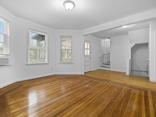 9-11 Edmunds St, Cambridge, MA 02140 - unfurnished living room with stairs, healthy amount of natural light, and wood finished floors