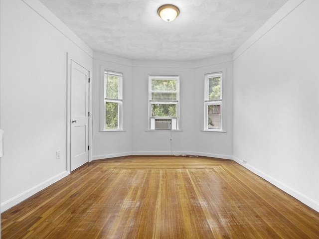 9-11 Edmunds St, Cambridge, MA 02140 - unfurnished room featuring plenty of natural light, hardwood / wood-style flooring, baseboards, and cooling unit