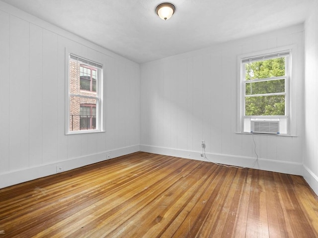 9-11 Edmunds St, Cambridge, MA 02140 - empty room with light wood-style flooring, cooling unit, and baseboards