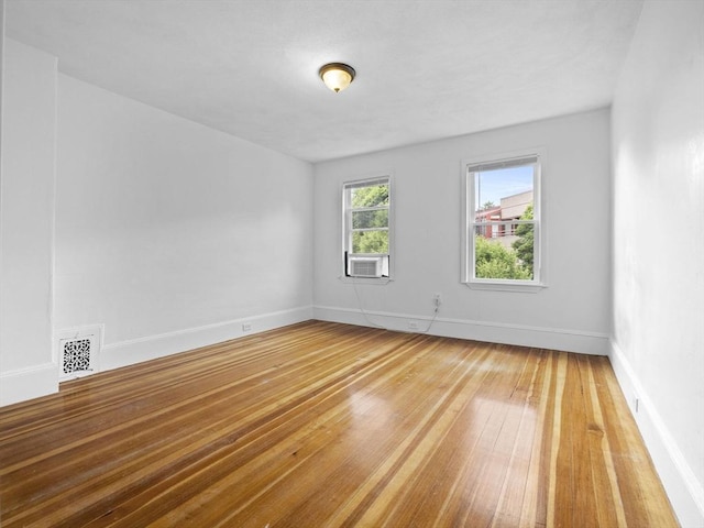 9-11 Edmunds St, Cambridge, MA 02140 - spare room featuring hardwood / wood-style flooring, baseboards, and cooling unit