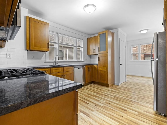 9-11 Edmunds St, Cambridge, MA 02140 - kitchen with appliances with stainless steel finishes, a sink, exhaust hood, brown cabinets, and tasteful backsplash