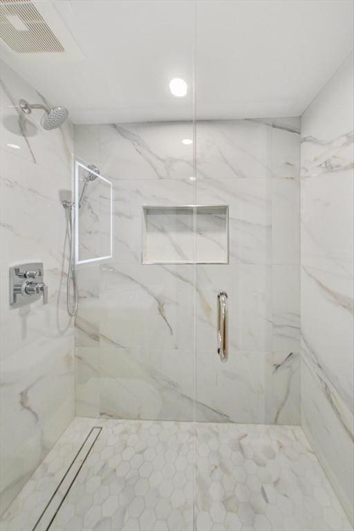 bathroom with a tile shower