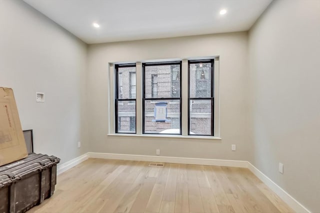 spare room with light wood-type flooring