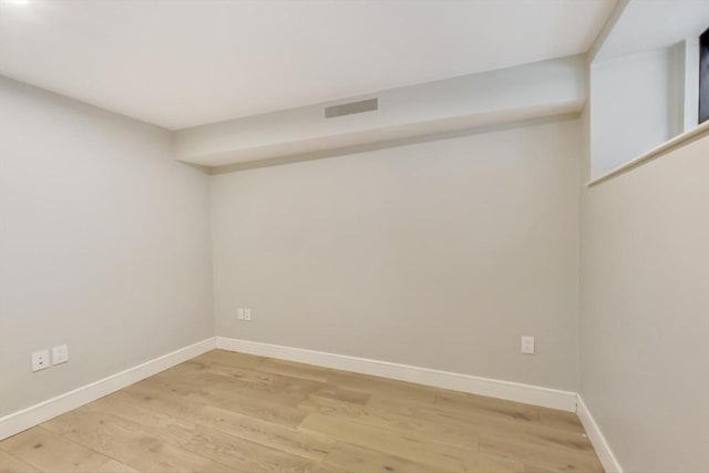 unfurnished room with wood-type flooring