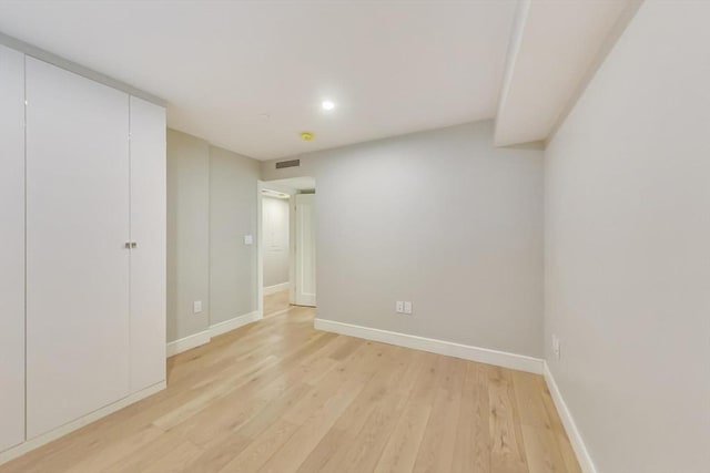 spare room with light wood-type flooring