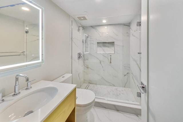 bathroom featuring vanity, toilet, and walk in shower