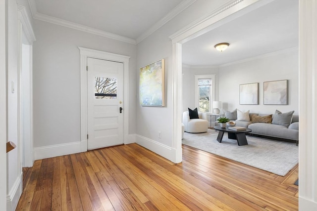 entrance foyer featuring crown molding and light hardwood / wood-style flooring