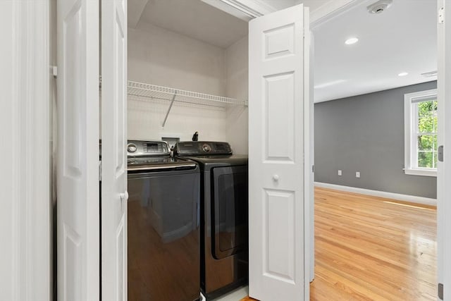 washroom with washer and clothes dryer, light wood finished floors, baseboards, and recessed lighting