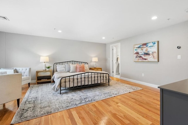 bedroom with light wood-style flooring, baseboards, and recessed lighting
