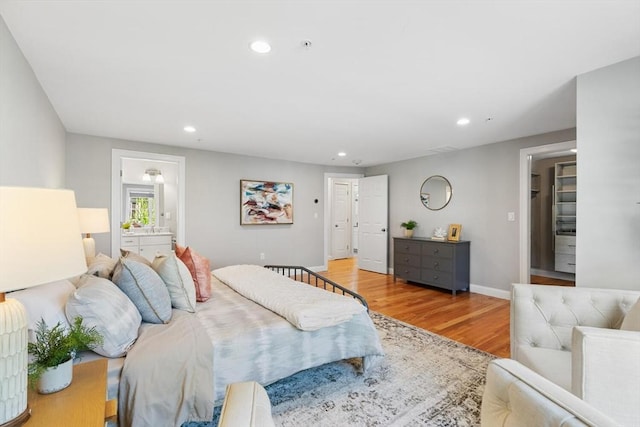 bedroom featuring recessed lighting, wood finished floors, and baseboards