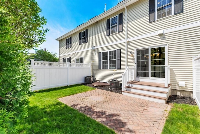 rear view of house featuring a patio area, entry steps, and central AC unit