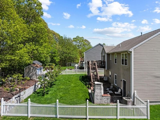 view of yard featuring a deck, stairs, and a patio