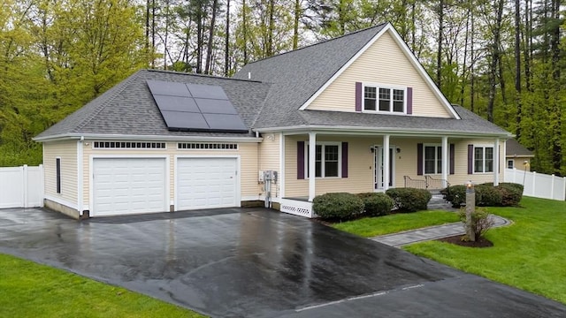 14 Chandler Ln, Amherst, NH 03031 - view of front of property featuring a porch, solar panels, driveway, roof with shingles, and an attached garage