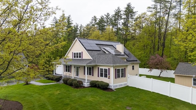 14 Chandler Ln, Amherst, NH 03031 - view of front facade featuring a porch, roof mounted solar panels, and roof with shingles